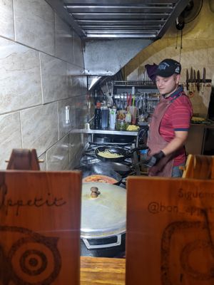 View of the kitchen from the seat (right after an impressive fire!) at Bon Appetit in Jardin