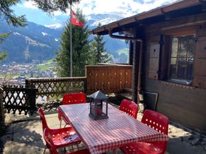 Dining table outside upstairs apartment at Chalet Chez Teddy in Lenk Im Simmental