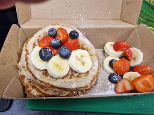 Vegan pancakes with maple syrup and fruit  at The Happy Shroom in Gloucester