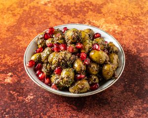 ZAYTOUN PARVARDEH .Green olives marinated in pomegranate molasses, ground walnuts & spices. at Mana's Plant-Based Persian Cuisine in London