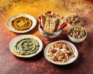 SINI-E MAZEH .
Mezze sharing platter: all 5 of above dishes & sharing portion of clay- oven baked barbari bread. at Mana's Plant-Based Persian Cuisine in London