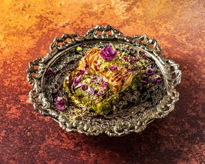 MAMAN'S BAGHLAVA .
Sweet phyllo, crushed pistachios, rose petals and date syrup. at Mana's Plant-Based Persian Cuisine in London