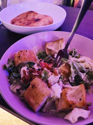 in the foreground is a salad with soy meat, aioli dressing, sesame seeds and (large) toasted bread crumbs. in the background is an imeretian khachapuri at SHPANA in Tbilisi