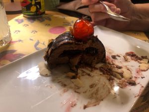 Chocolate ice cream with a cherry sauce, coated in a chocolate shell, flakes almonds and a glacé cherry on top!  at I Morgante Bottegabistro in Agrigento