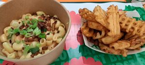Mac and cheese and bacon bits, and marmite waffle fries at Oowee Vegan in Brighton