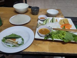 asked the lady how to roll the spring rolls at Quan Chay Buffet Lac Tam Vegan in Hue