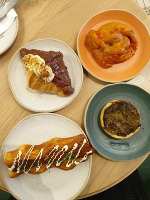Ferrero Rocher Croissant €5.00; Like a Pizza €4.70; Quiche €4.50; Puff Dog €6.50 at Holy Llama - Sintagma in Athens