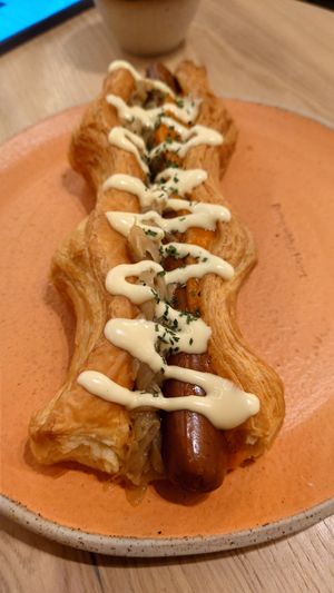 Puffy Dog (hot dog with puffy pastry instead of bread) and dijonaise (Dijon mustard with mayo). The sausage is tofu made. at Holy Llama - Sintagma in Athens