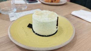 An "Exotic" dessert. Coconut sponge cake, has mango in the center which makes it just a perfect combination of flavours. Exquisite. at Holy Llama - Sintagma in Athens