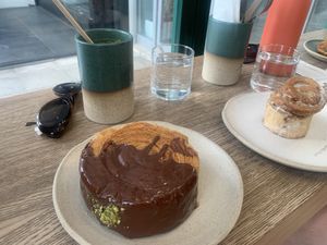 Pistachio pin wheel, fredo cappuccino and cinnamon bun   at Holy Llama - Sintagma in Athens