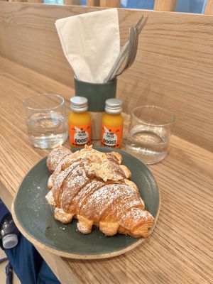Turmeric & orange shot and almond croissant . 🥐   at Holy Llama - Sintagma in Athens