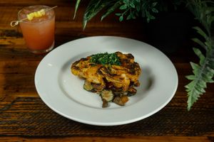 Cauliflower "Steak" (Entrees) - Spicy Masala seasoned with gremolata, curried chickpeas and roasted vegetables.  at Roots in Riverside