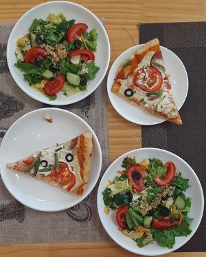 Fresh vegetable salad; Pizza at Vegan House in Ulaanbaatar