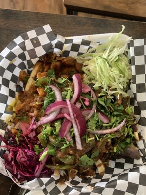 Loaded fries topped with pollo, carne asada, and chorizo meats  at The Vegan Vato in Victorville