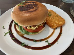 Egg and bacon roll with a hash brown   at Miss Sina in Marrickville