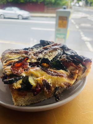 Pizza slices with veggies  at Miss Sina in Marrickville