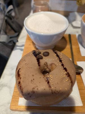 Coffee doughnut and a cup of oat milk  at Espresso Mafia  in Girona