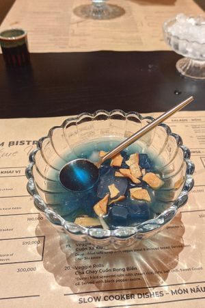 Complimentary sugar water with crispy coconut dessert at Cai Mam Bistro - Signature Vegan in Hanoi