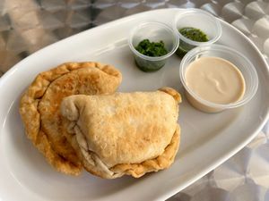 Sambousek with tahini, hot paste and fenugreek sauce at Beyond Falafel in Quarteira