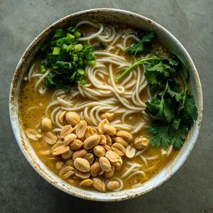 Creamy broth with peanuts, mushrooms, tofu, spring onions and coriander at Yasai Ramen in Lisbon