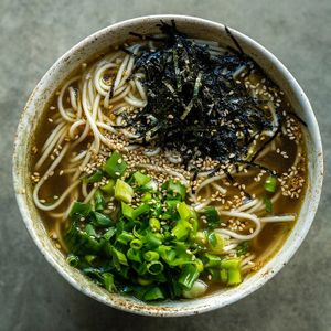 Broth with a hint of salt and sake, topped with spring onions and shredded noori at Yasai Ramen in Lisbon