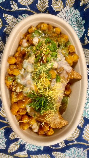 Samosa Chaat - two samosas (you pick from three flavors) tandoori roasted chickpeas, chutneys, cumin raita, garnishes  at Samosa Shack in Kingston