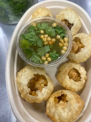 Pani Puri - iconic Indian street food. Crispy mini puris stuffed with spicy potato-chickpea-lentil mix, tamarind chutney, spicy mint water  at Samosa Shack in Kingston