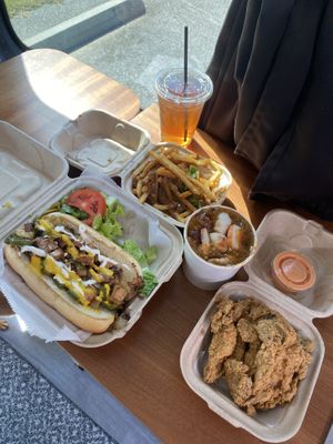 Chicken Philly sandwich, chili queso fries, fried oyster mushrooms, gumbo with shrimp and sausage and an unsweetened mango tea  at The Social Vegan - SV Lounge - Maybe closed in Tallahassee