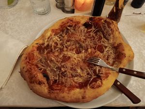 Lovely pizza with a fake pepperoni thing - huge portion! at PiranArt Restaurant & Gelateria & Caffeteria in Piran