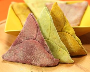 Trio that mixes colors and explosion of flavors. Pink Esfiha with Caramelized Onion filling, Green Esfiha with Carrot and Garlic Sauce filling and Yellow Esfiha w at Lemí in Rio De Janeiro