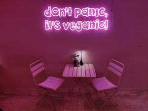 Table with neon light at RAZZO Vegan Pizza Bar in Cologne