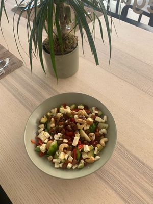 Salad of brussels sprouts, vegan cheese, pomegranate, avocado, raisins, cashews and cherry tomatoes. at Green Bistrot in Guimaraes