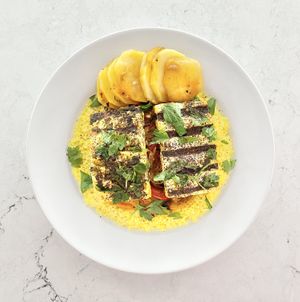 Grilled tofu fillet over couscous and middle eastern style veggies   at Veganista HI in Honolulu