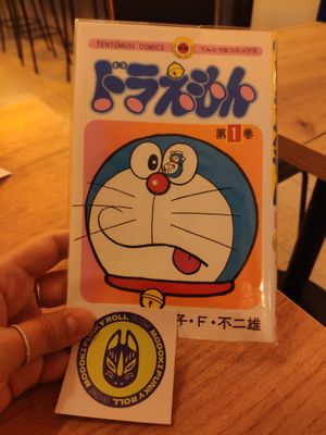 Doraemon bill holder (where they give you the bill/check) and logo sticker at Modoki Funky Roll in Barcelona