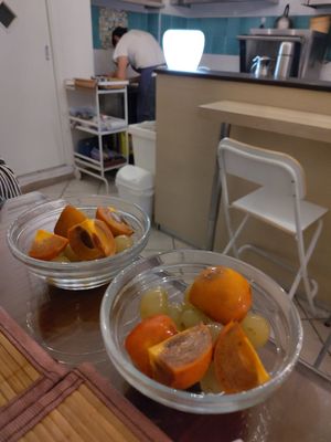 Kaki with grapes dessert. And hardworking chef in the background at Piccola Gastronomia da Elsa in Salerno