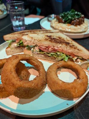 BLT with onion rings, Golden era chick-un & waffle in the background at Urban Vegan Kitchen in New York City