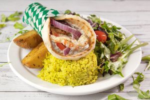 Shrimp Pita Plate with Greek Lemon Roasted Potatoes, Greek Lemon Rice and House Mixed Greens Salad. at Veganarie - Resto Végan in Montreal