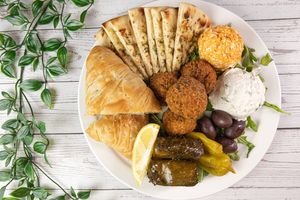 Pikilia for 2.
Includes; Spanakopita, Falafel, Tzatziki, Kopanisti, Domades, Olives, Peperoncini and Pita Bread. at Veganarie - Resto Végan in Montreal