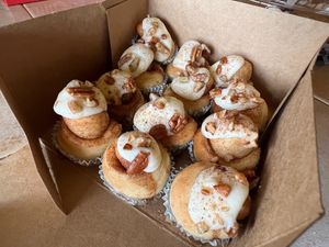 Bite-sized baby buns topped with cream cheese frosting and pecans at Cinnaholic in Carmel