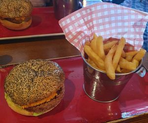 Main: Poppy seed bun layered with a Meatless Farm burger, guacamole,

red pepper houmous, chunky grilled red onion and lettuce. Served with
Fries and ketchup. at Hungry Horse - Matchstick Man in Salford