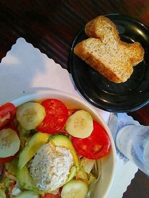 Stuffed Avocado Salad with Vegetarian Chicken Salad: A large salad topped with 4 slices of avocado and a generous mound of vegetarian chicken salad.  at Christian and Jake's Bistro in Calhoun