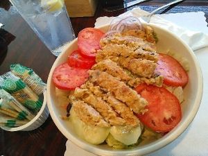 Garden Burger Salad: As with all C&J's salads, this was served in a large bowl--a very generous portion. It had a nice selection of vegetables with the lettuce. When requested, they left off the cheese and added extra cucumber. The garden burger sliced over the top was a large one, and appeared homemade. Includes a side of crackers or bread, and a dressing of one's choice. at Christian and Jake's Bistro in Calhoun