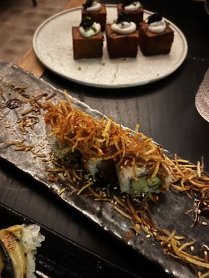 Fire cracker roll with 1,000 layer crispy potatoes in background. Roll was delicious, but the potatoes are worth skipping.   at Planta Queen in Chicago