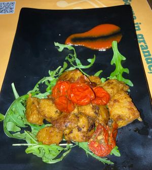 Seitan bites with salad, confit tomatoes black powdered garlic  at Veghometro in Rome