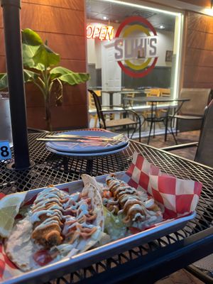 Vegan fish tacos with sign in back at Suki's Vegan in Gainesville