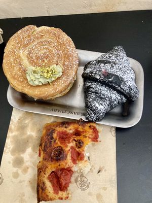 Roll with pistachio, croissant with raspberry and some creamy vanilla foam and foccasia with tomatoes  at The Sanctuary in Berlin