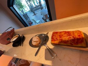 Sorry for the shadow! Pizza focaccia + pastry & flat white.  at The Sanctuary in Berlin