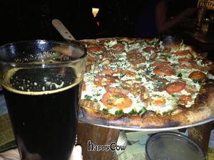 Vegan cheese pizza and beer at Sticks and Stones Clay Oven Pizza in Greensboro
