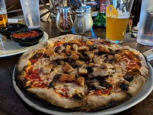 Small pizza with Vegan chicken, vegan cheese, and mushrooms at Sticks and Stones Clay Oven Pizza in Greensboro