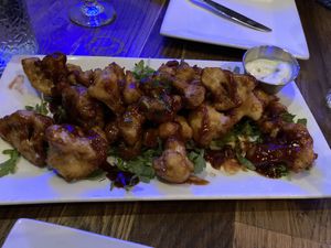 Vegan cauliflower tempura wings with Korean bbq sauce.  Note the cup of non-vegan sauce that came with it. Not cool    at Bar Grazie in Massapequa Park